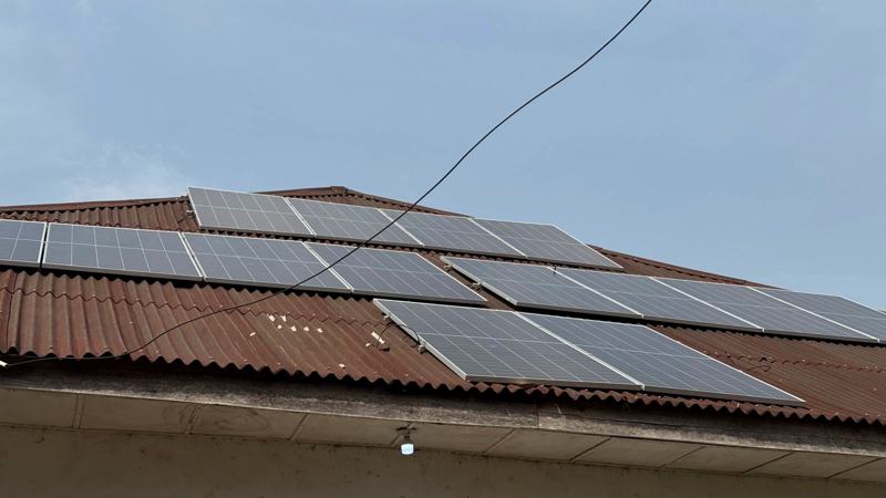 Solar panels against a wide blue sky