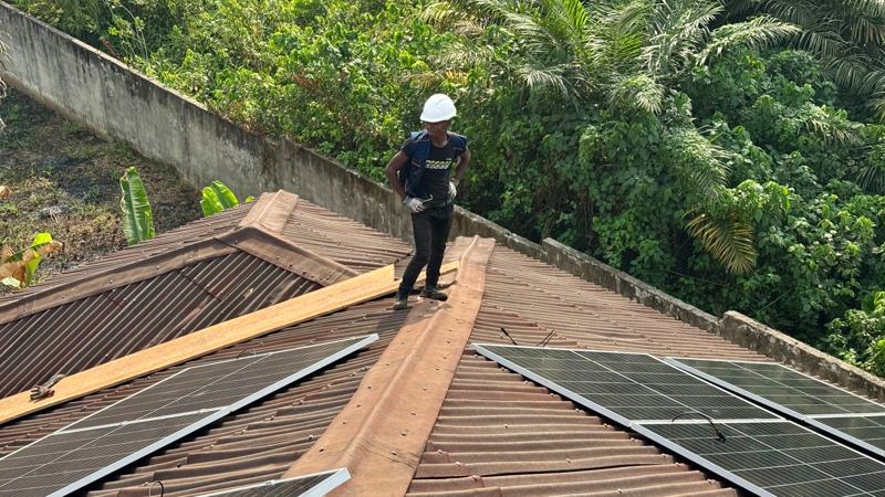 Installer walking the ridge of a roof with fresh panels